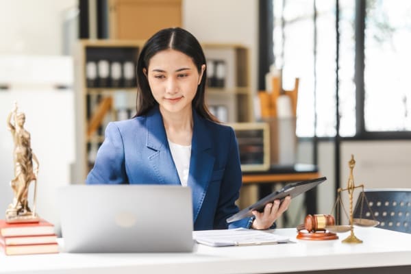 A paralegal using a laptop in a law office